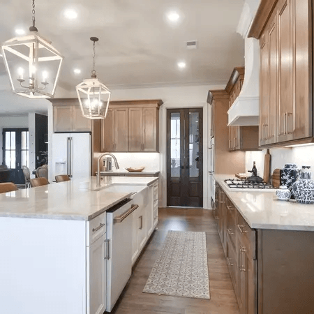 Kitchen interior showcasing a navy blue island and white perimeter cabinetry.